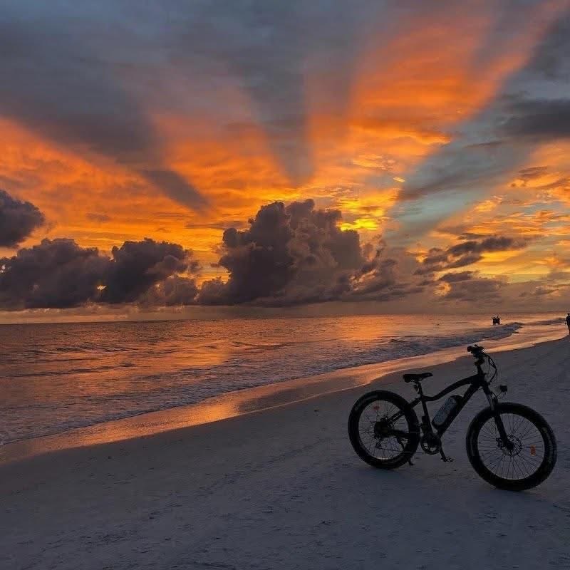 Bike on beach at sunset
